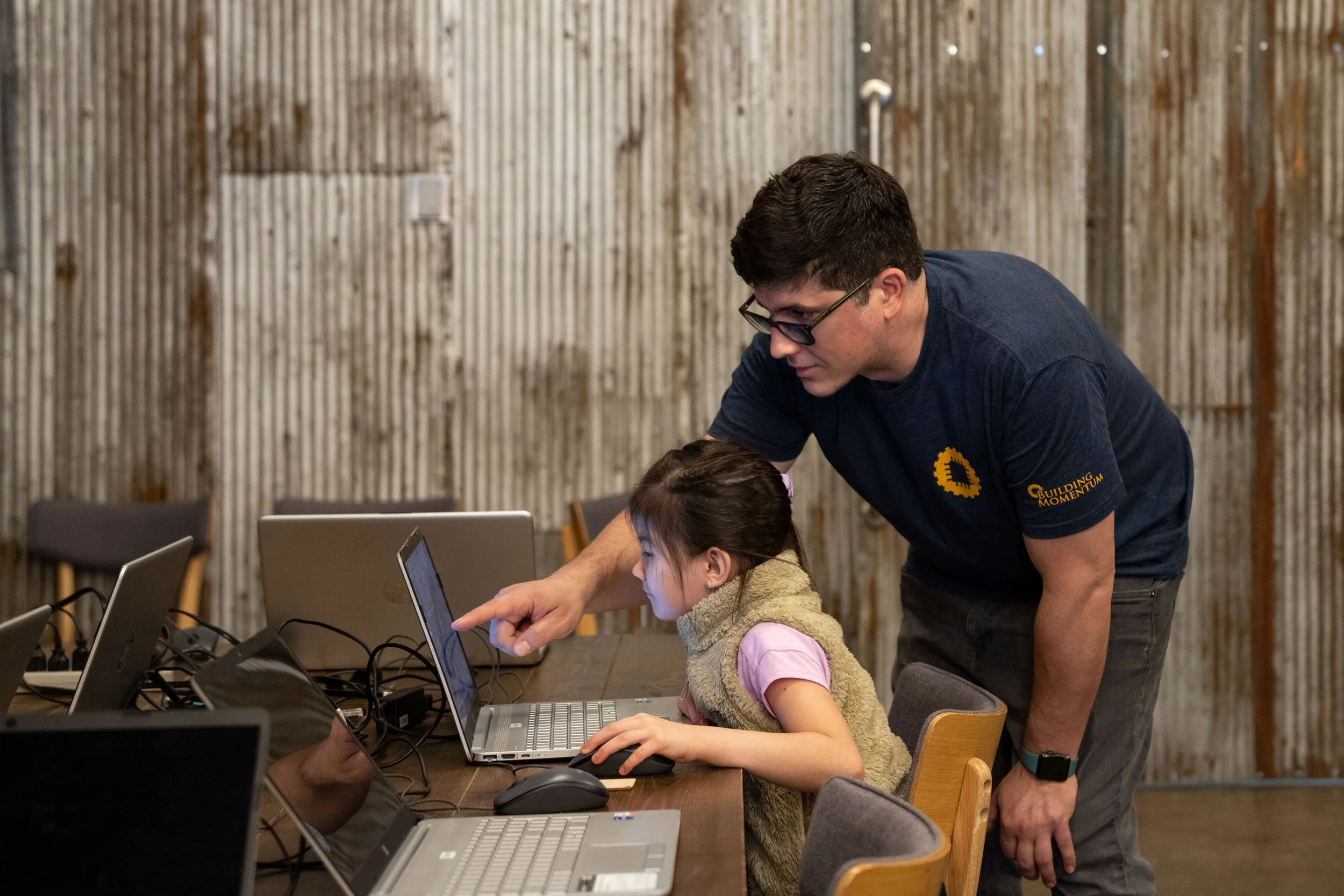Student flying a drone indoors